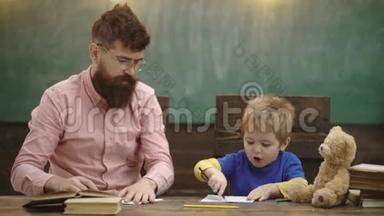 <strong>幼儿教育</strong>与游戏观念。 爸爸带着儿子画画。 爸爸和小男孩一起画画。 学校